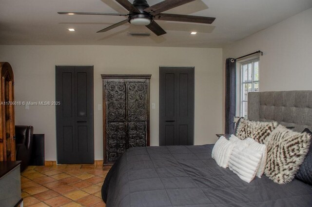 bedroom with ceiling fan and light tile patterned floors