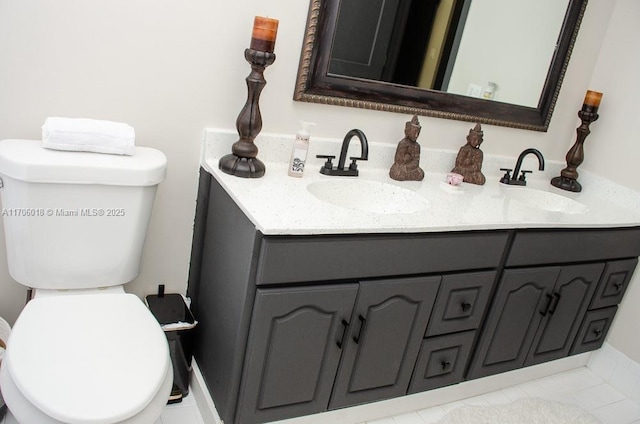 bathroom featuring tile patterned floors, vanity, and toilet