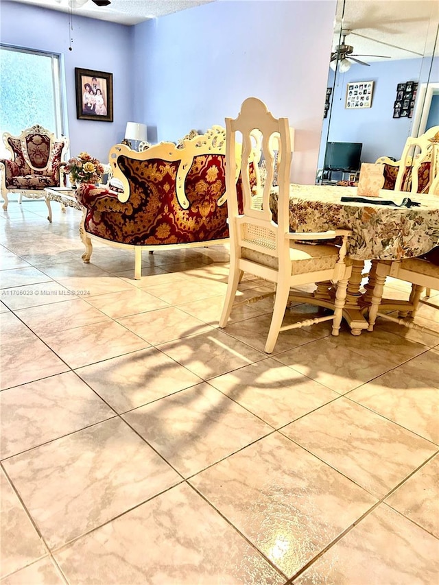 dining room featuring ceiling fan and a textured ceiling