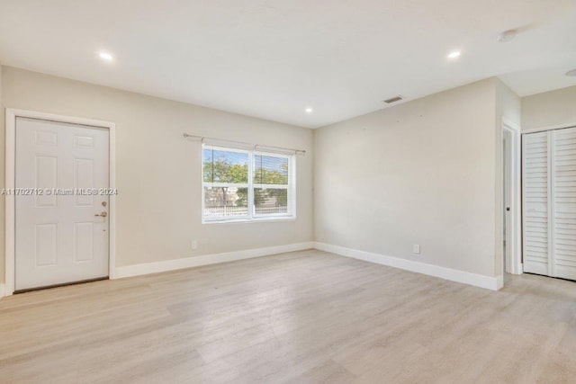 empty room with light hardwood / wood-style floors