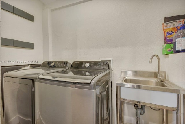 laundry area with washing machine and dryer and sink