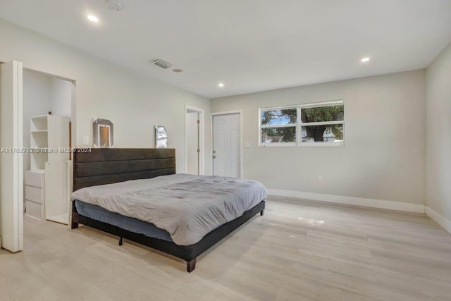 bedroom with a closet and light hardwood / wood-style flooring