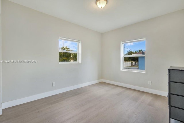 unfurnished room with light wood-type flooring