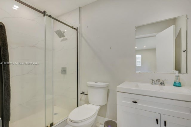 bathroom featuring vanity, toilet, and an enclosed shower