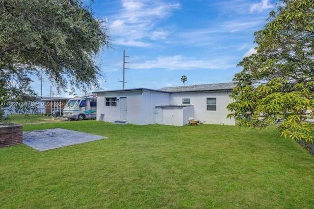 rear view of house featuring a lawn