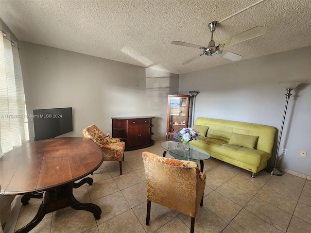 tiled living room featuring ceiling fan and a textured ceiling