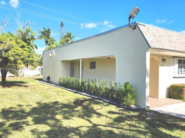 view of side of home with a yard