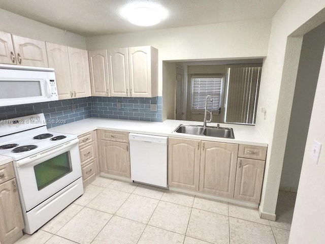 kitchen with white appliances, backsplash, sink, light tile patterned floors, and light brown cabinetry