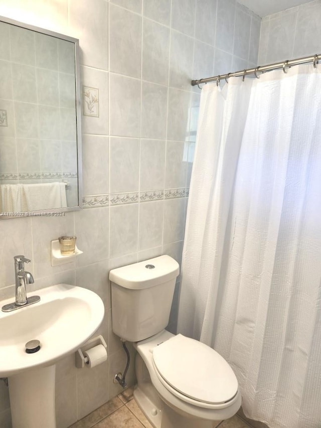 bathroom featuring tile patterned floors, walk in shower, tile walls, and toilet