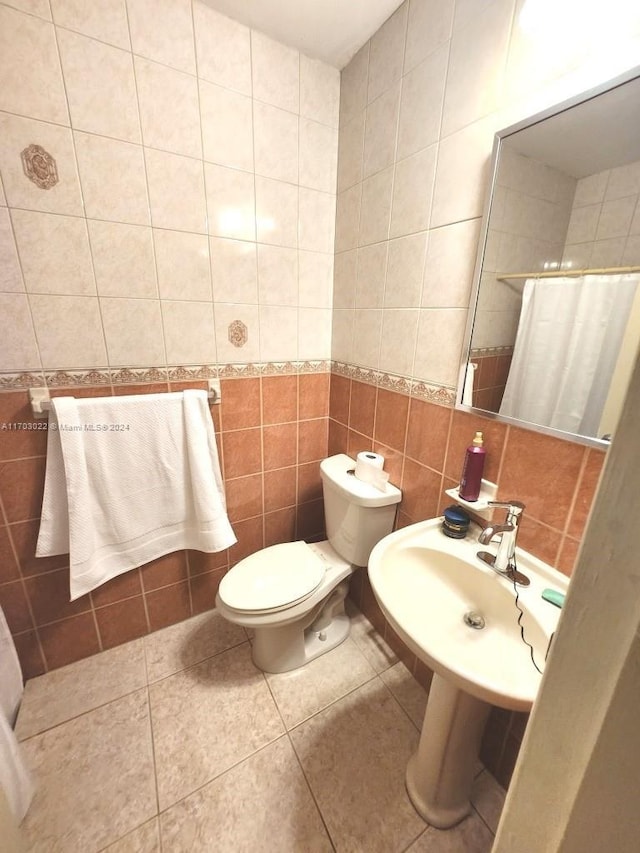 bathroom featuring tile patterned flooring, toilet, tile walls, and a shower with shower curtain