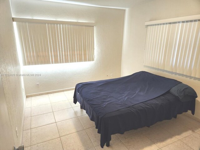 bedroom with light tile patterned floors