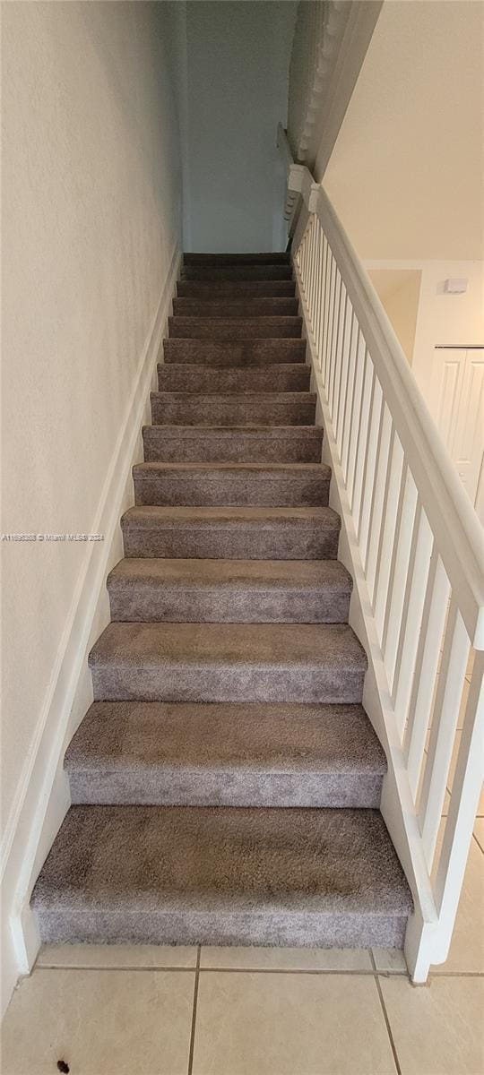 stairs with tile patterned flooring