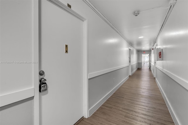 corridor with wood-type flooring