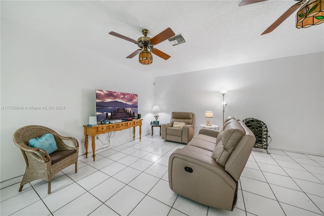 tiled living room featuring a textured ceiling