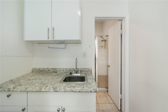 kitchen with white cabinetry and sink