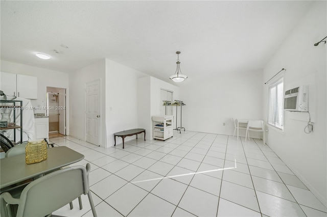 living room featuring a wall mounted air conditioner and light tile patterned floors