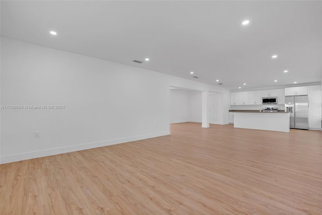 unfurnished living room with light wood-type flooring