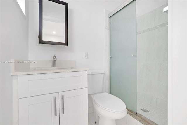 bathroom featuring vanity, toilet, and an enclosed shower