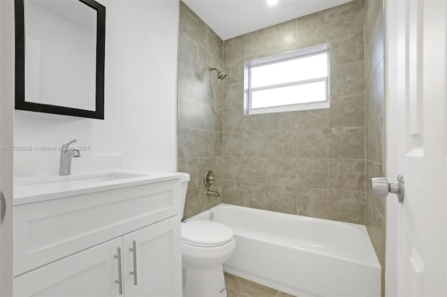 full bathroom with tile patterned flooring, toilet, vanity, and tiled shower / bath