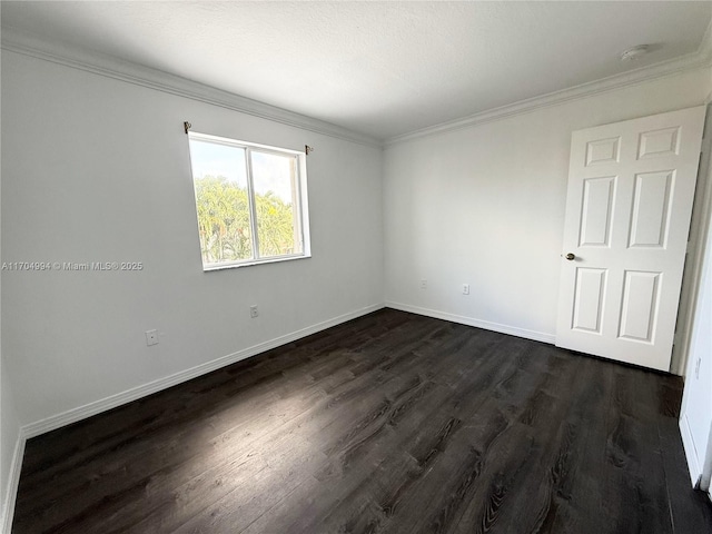 empty room featuring crown molding and dark wood-type flooring