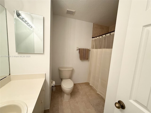 bathroom featuring walk in shower, vanity, a textured ceiling, and toilet