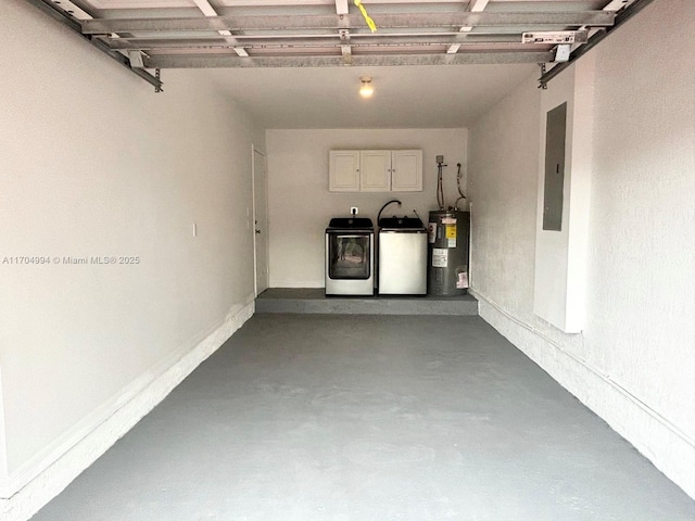 garage featuring washer and clothes dryer, electric water heater, and electric panel