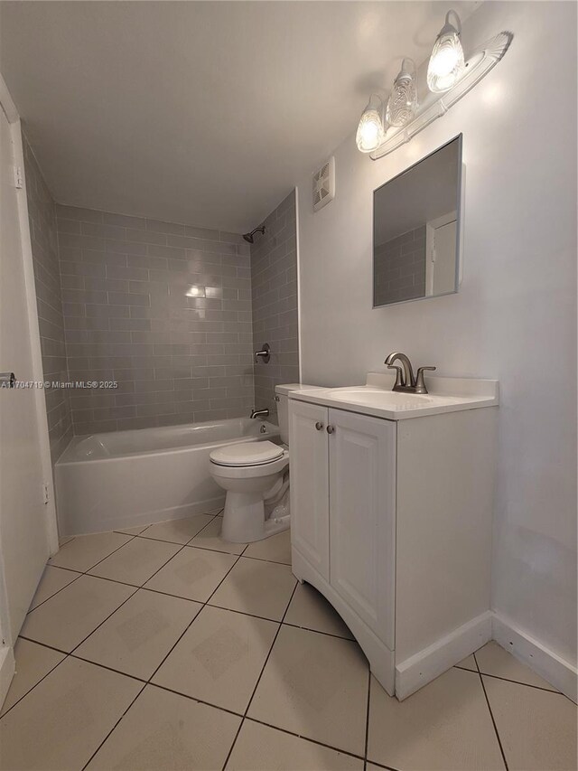 full bathroom with tile patterned floors, vanity, toilet, and tiled shower / bath