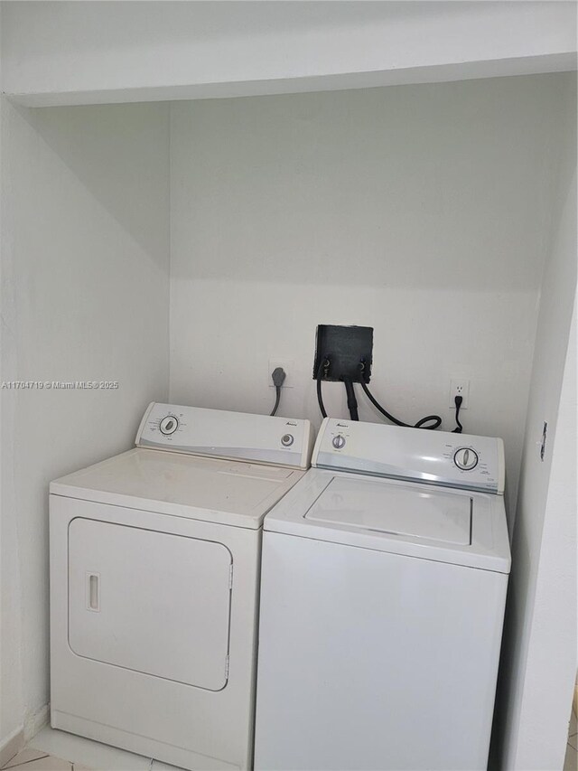 laundry room featuring washing machine and clothes dryer