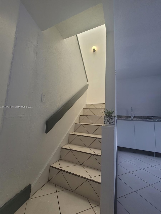 stairs featuring tile patterned flooring