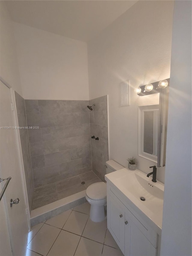 full bathroom featuring toilet, tile patterned floors, a shower stall, and vanity