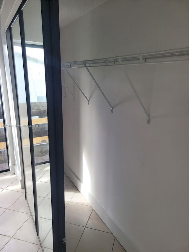 spacious closet featuring light tile patterned floors