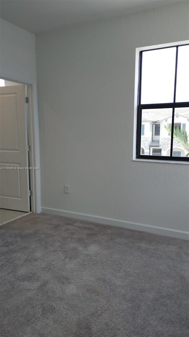 13313 SW 286th Ter Unit 13313, Homestead, FL 33033 - carpeted spare room featuring baseboards