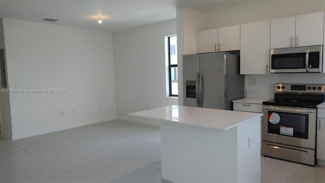 kitchen featuring white cabinets, appliances with stainless steel finishes, and a kitchen island