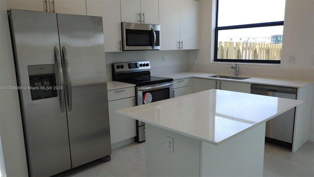13313 SW 286th Ter Unit 13313, Homestead, FL 33033 - kitchen featuring stainless steel appliances, a kitchen island, white cabinetry, and light stone countertops