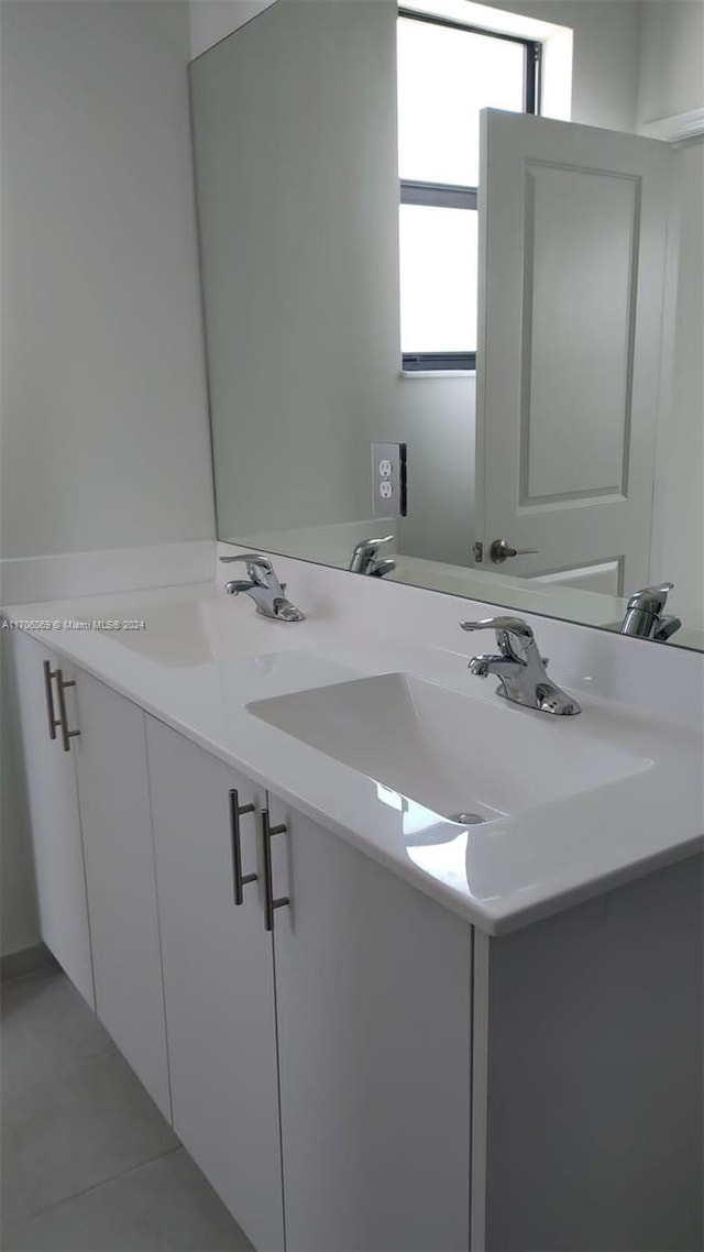 bathroom with tile patterned flooring and vanity