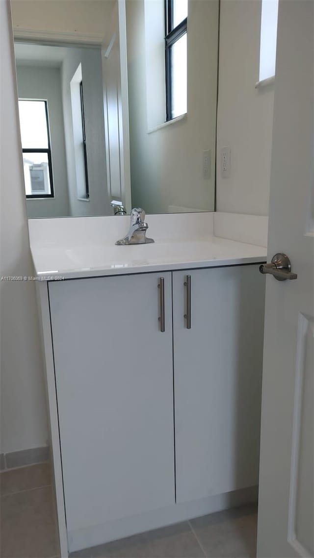 bathroom with tile patterned floors and vanity