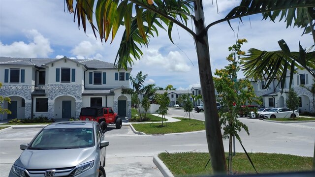 13313 SW 286th Ter Unit 13313, Homestead, FL 33033 - view of asphalt street featuring curbs, a residential view, and sidewalks