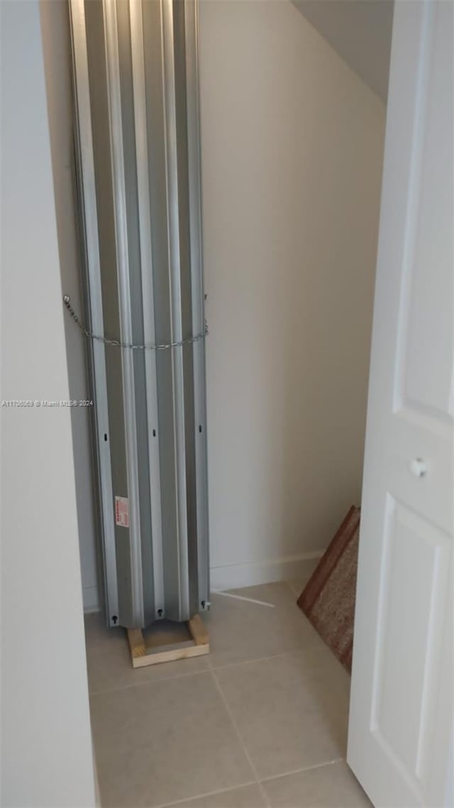 hallway featuring light tile patterned flooring