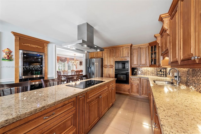 kitchen featuring black appliances, sink, light stone countertops, light tile patterned flooring, and island exhaust hood