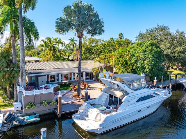 dock area with a water view and a patio area