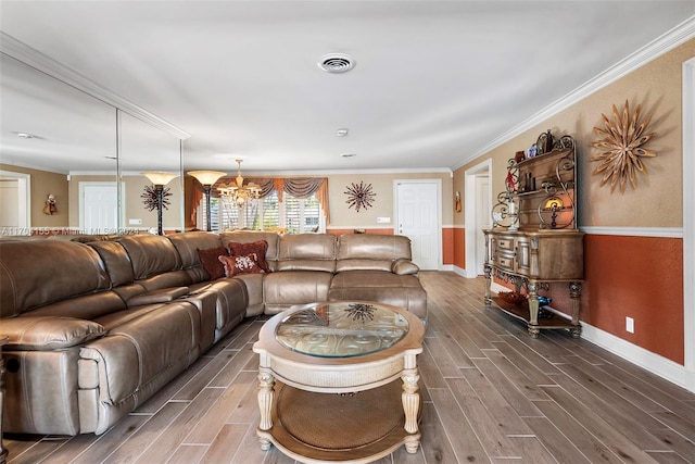 living room with a chandelier, dark hardwood / wood-style flooring, and crown molding