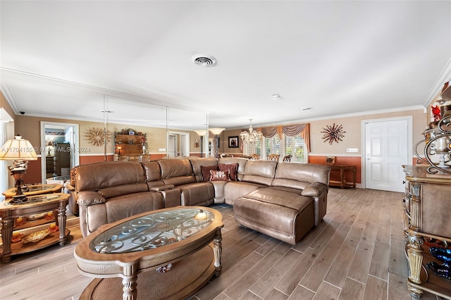 living room featuring a chandelier, ornamental molding, and hardwood / wood-style flooring