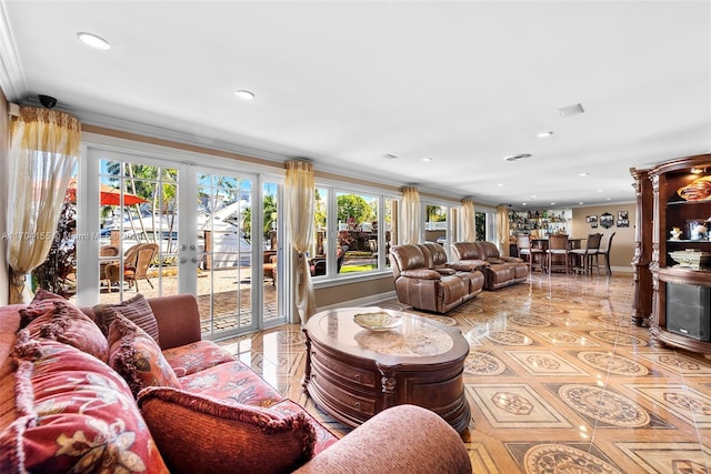 living room with french doors, light tile patterned floors, and ornamental molding