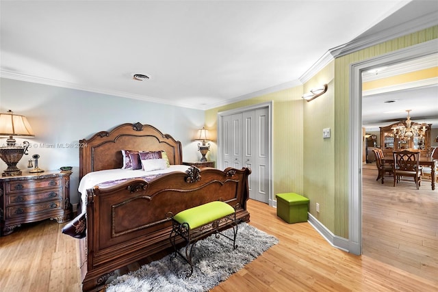 bedroom with a closet, crown molding, and light hardwood / wood-style flooring