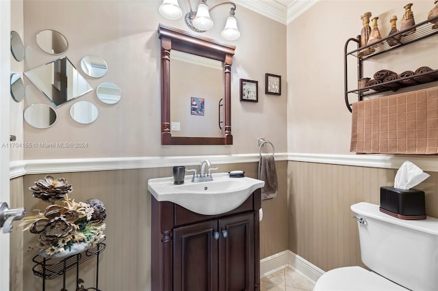 bathroom featuring tile patterned floors, vanity, toilet, and crown molding