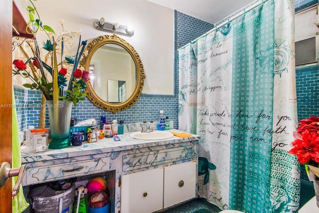 bathroom with a shower with shower curtain, vanity, and tile walls