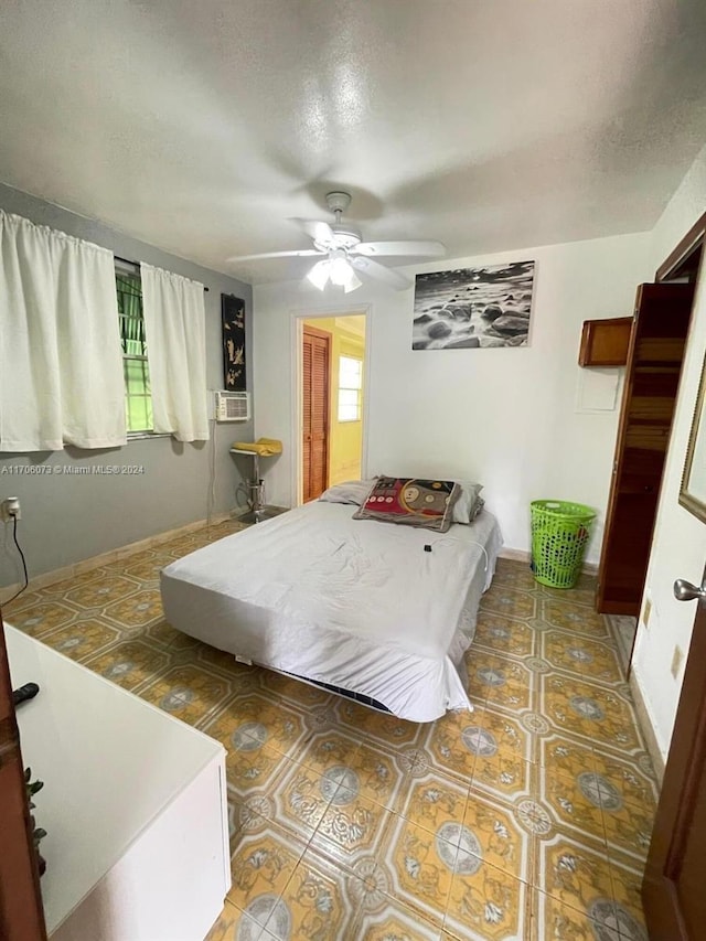 bedroom with multiple windows, ceiling fan, and tile patterned flooring