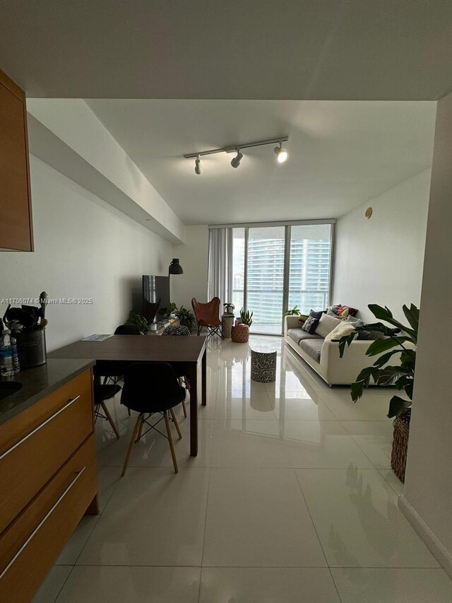 465 Brickell Ave Unit 4004, Miami, FL 33131 - dining space with light tile patterned flooring, rail lighting, and expansive windows