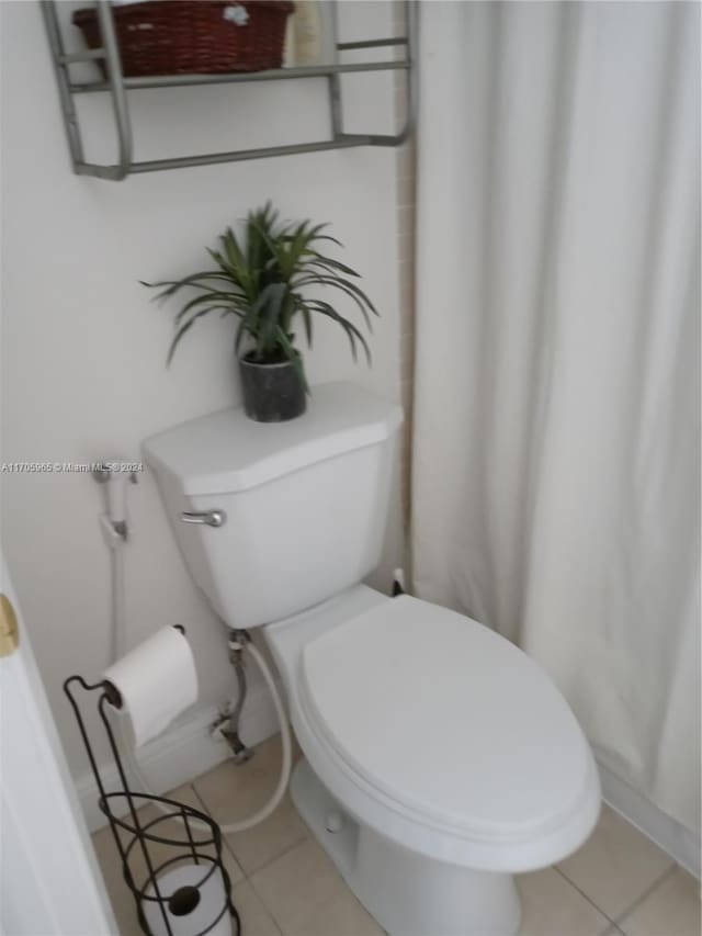 bathroom featuring tile patterned flooring and toilet