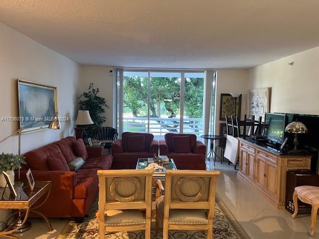 tiled living room with a textured ceiling